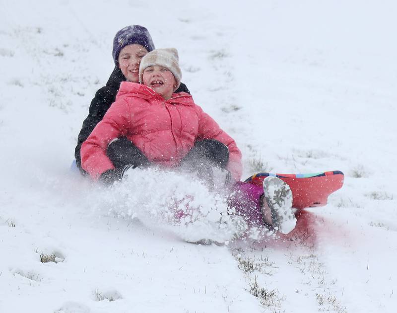 Kendall McMacken, (front) 10, and her brother Camden, 12, from Sycamore, sled Saturday, Nov. 29, 2025, on the Northwestern Medicine Sled Hill near the Sycamore Park District Community Center.