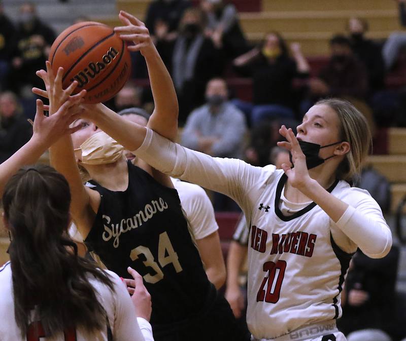 Sycamore’s Reese Hill battles for a rebound with Huntley’s Jori Heard during a non-conference basketball game Monday evening, Jan. 24, 2022, between Sycamore and Huntley at Huntley High School.