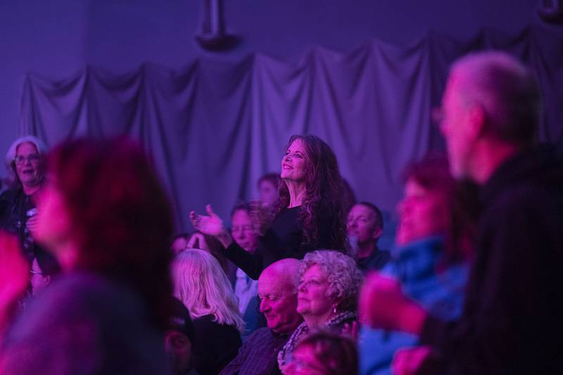 Fans of Head East sing along and gesture Saturday, April 22, 2023 during their show at the Dixon Historic Theatre.