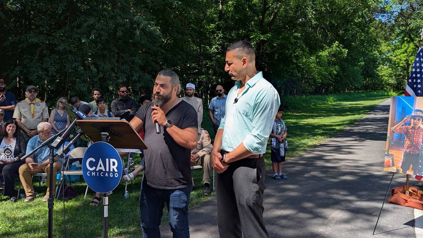 Odai Alfayoumi, father of Wadee Alfayoumi, (left) thanked everyone for not forgetting his son, during the dedication of Wadee's monument on Saturday, June 28, 2025 at Van Horn Woods East Playground in Plainfield. Ahmed Rehab, executive director, CAIR-Chicago (right), translated Odai Alfayoumi,'s message.