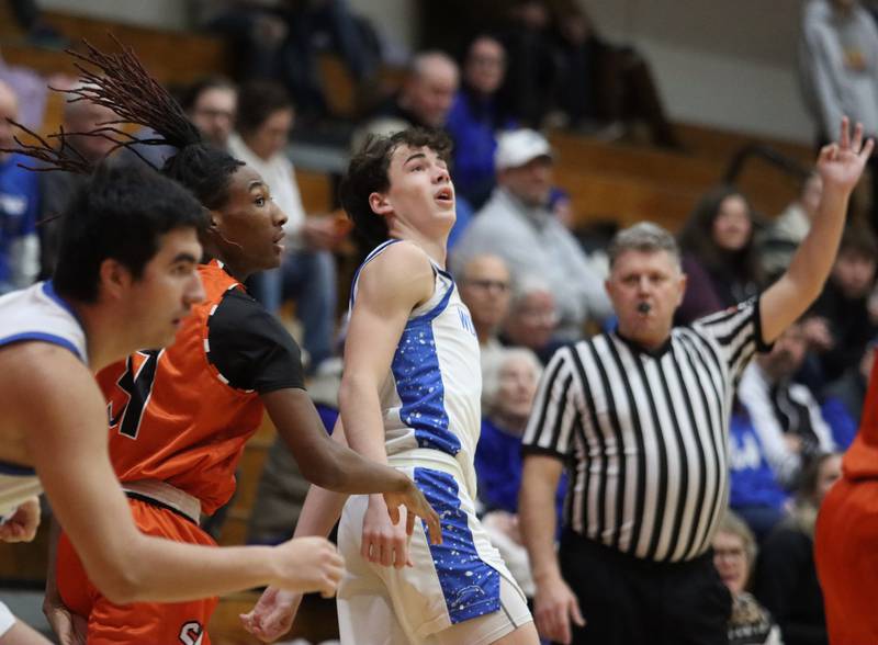 Woodstock’s Collin Greenlee watches his three-point shot against Sandwich in varsity boys basketball on Tuesday, Feb. 11, 2025, at  Woodstock High School in Woodstock.
