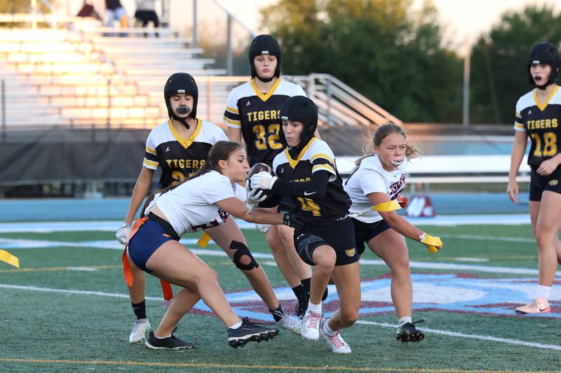 Joliet West's Ella Featherston is stopped by Oswego's Leona Bateman, left, and Cynara Jackson during the Panthers' 13-7 victory over Joliet West on Tuesday, Oct. 7, 2025.
