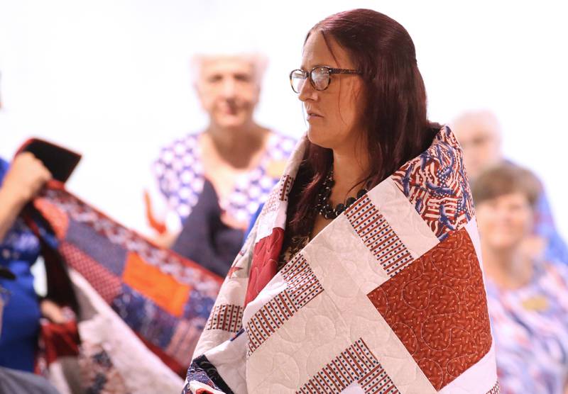 U.S. Army Veteran Amanda Gibson, of Princeton, receives her Quilt of Valor during the Tribute to Veterans on Wednesday, Aug. 20, 2025 at the Bureau County Fair in Princeton.
