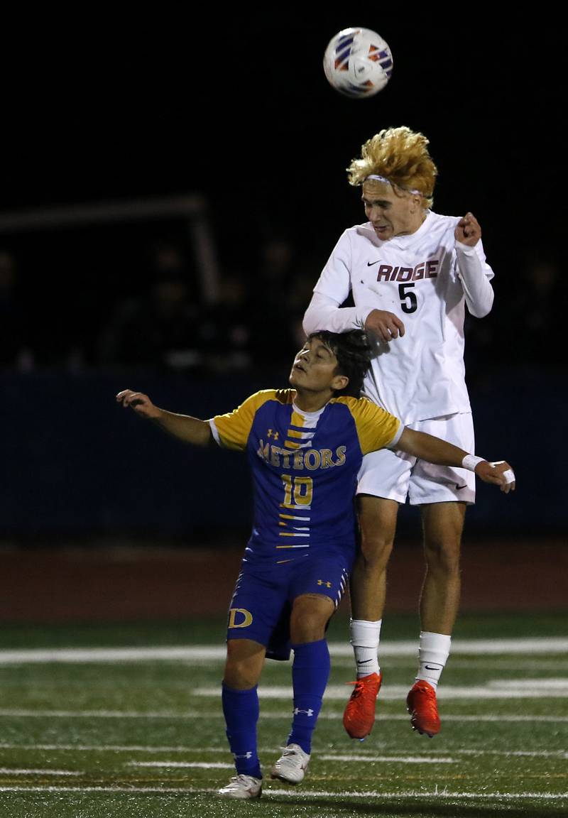 Prairie Ridge's Brandon Matei heads the ball away from Chicago De La Salle's Brandon Olvera during an IHSA Class 2A state semifinal soccer match on Friday, Nov. 8, 2024, at Hoffman Estates High School.