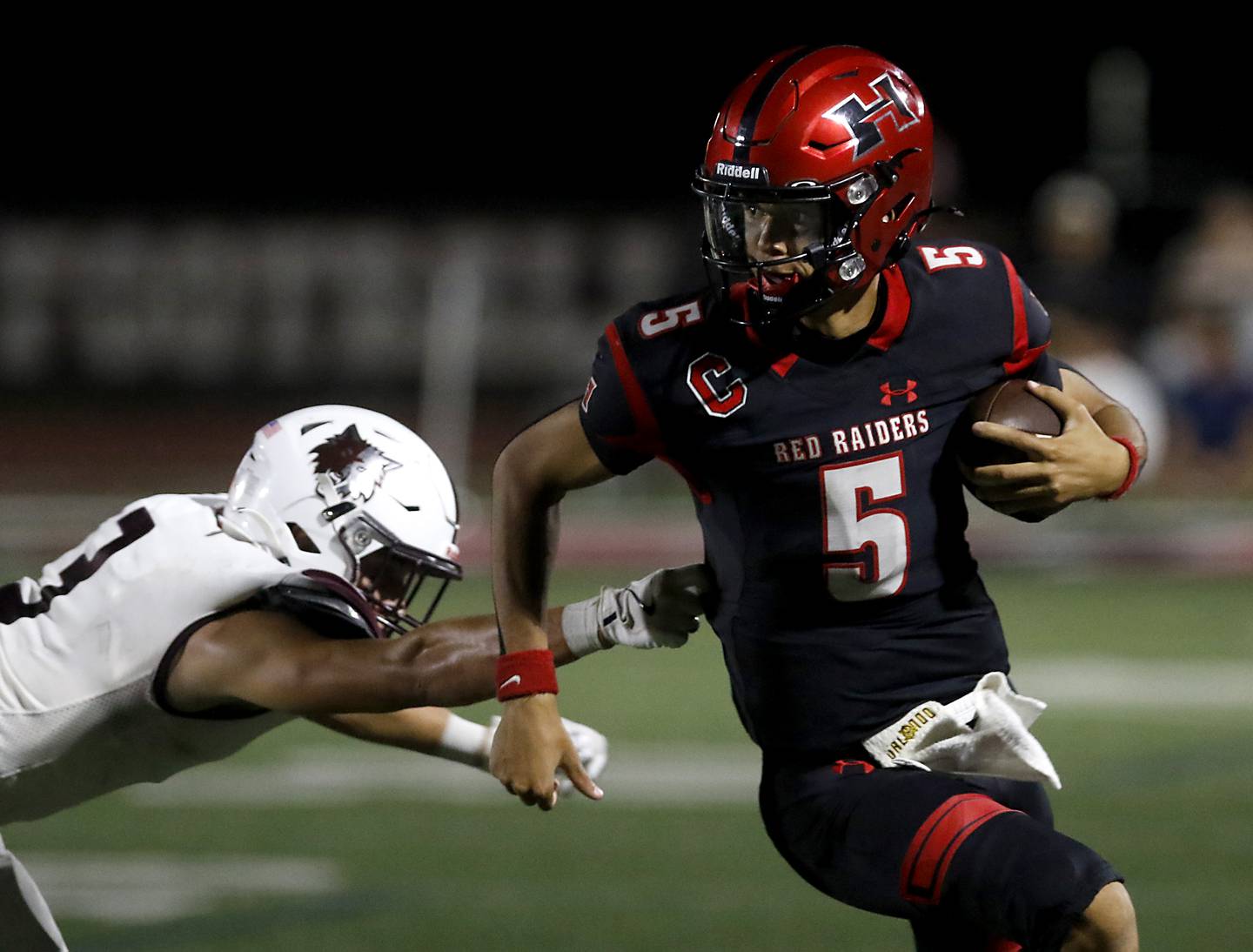 Prairie Ridge's Elijah Loeding tries to tackle Huntley's Malik Carter during a Fox Valley Conference football game on Friday, Oct. 3, 2025, at Huntley High School.