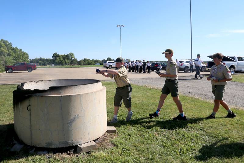 Boyscout from Troop 123 and Cub Scouts Pack 3709 place American Flags into a burning cauldron during a Flag Retirement Ceremony on Friday, June 14, 2024 at Veterans Park in Peru.  The ceremony always takes place on Flag Day. It began as a Eagle Scout project for area boy scouts about 30 years ago. When an American Flag gets torn and tattered, Flag etiquette requires it to be proper disposed in a burning cauldron.