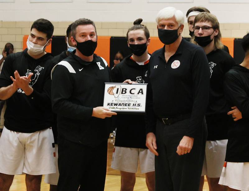 Steve Allen (right) of the Illinois Basketball Coaches Association presented coach Matt Clark and the Kewanee High School boys basketball program with a plaque for surpassing 1,500 all-time victories.