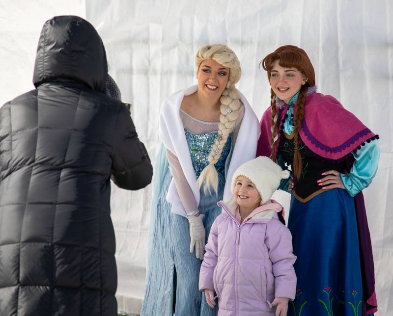 Navy Kauffman, 3, poses for a picture with the Snow Princess, right, and the Ice Queen during Wheaton Park District's Ice-A-Palooza at the Central Athletic Complex in Wheaton on Saturday, Feb. 4, 2023.