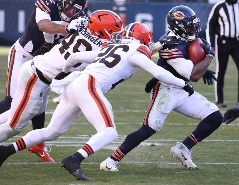 Chicago Bears running back D'Andre Swift pulls away from two Cleveland Brown defenders on his way to his second touchdown during their game Sunday, Dec. 14, 2025, at Soldier Field in Chicago.