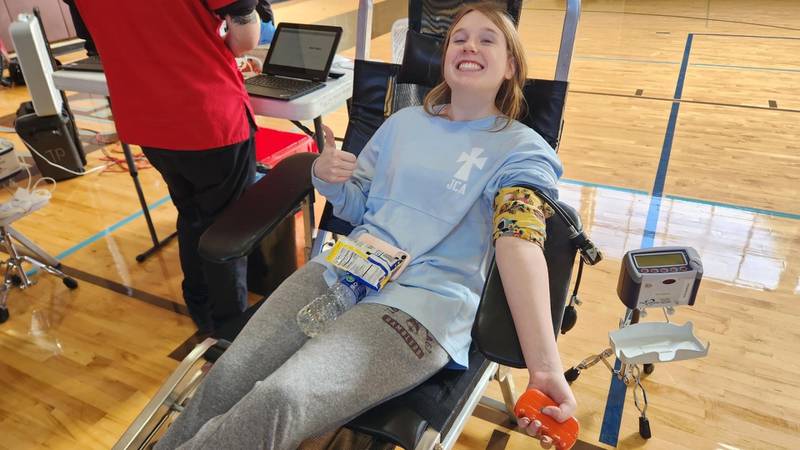 Joliet Catholic Academy student Natalie Hatfield donates blood on Monday, Oct. 23, 2023, at the Joliet school. JCA engaged in a friendly competition with Providence Catholic High School in New Lenox to see which school could collect more donations.