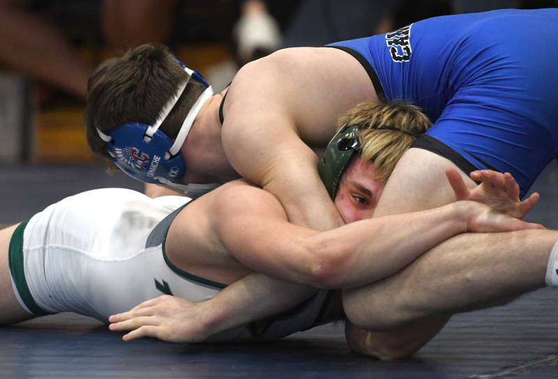 West Carroll's Jonner Smith reaches for the leg of Camache's Olyver Fuller in the 165-pound championship match at the Polo Wrestling Invitational on Saturday, Jan, 10, 2026 at Polo High School.