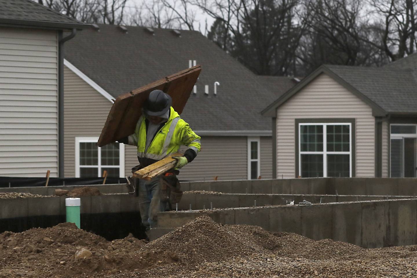 Workers from Upland Concrete, work on a foundation of a new home in the Woodlore Estates subdivision in Crystal Lake on Thursday, Jan. 19, 2023.