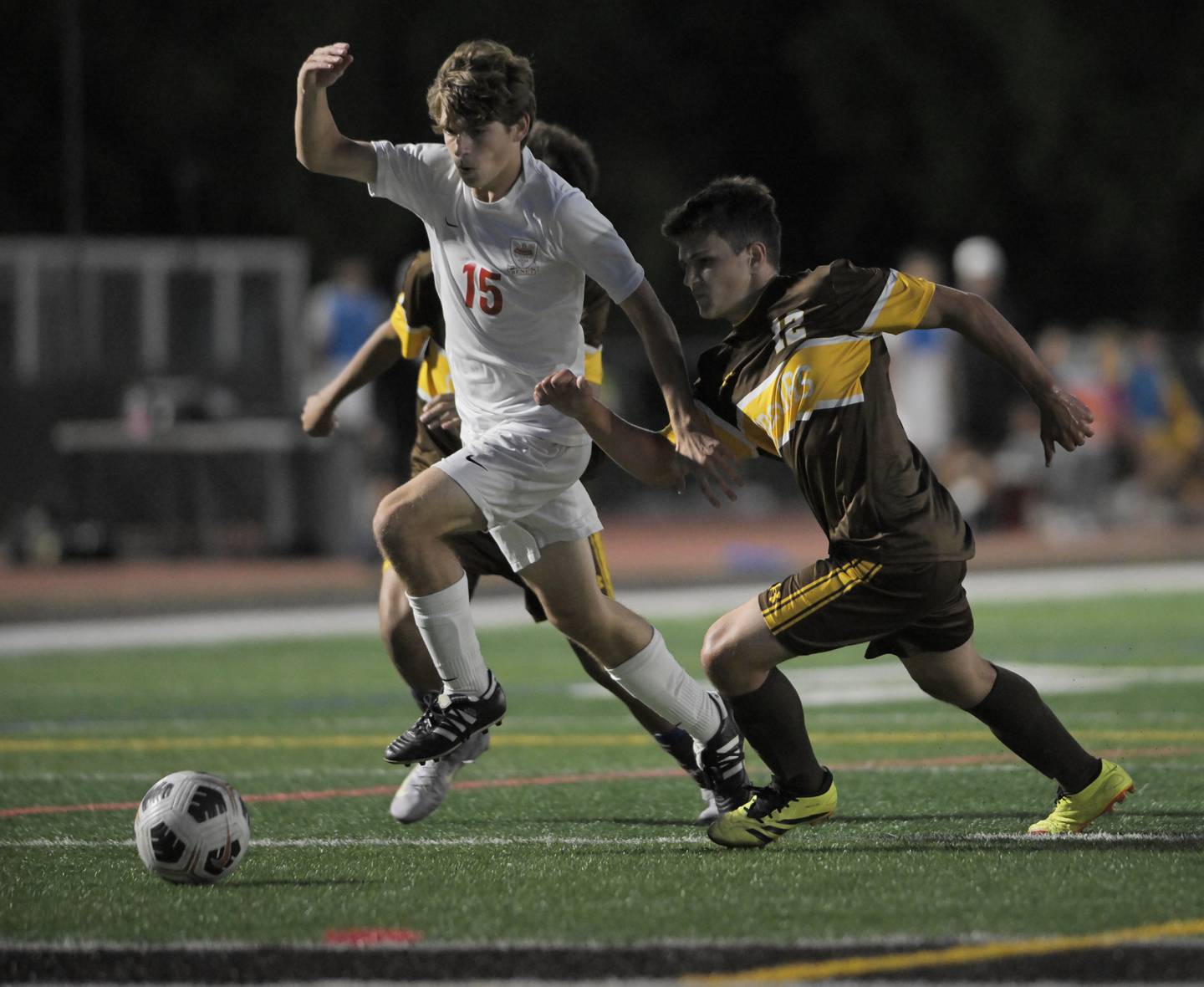 Benet’s Hayden Pinnello beats Carmel’s Garryn Thornberry to the ball in a boys soccer game in Mundelein on Wednesday, Sept. 17, 2025.