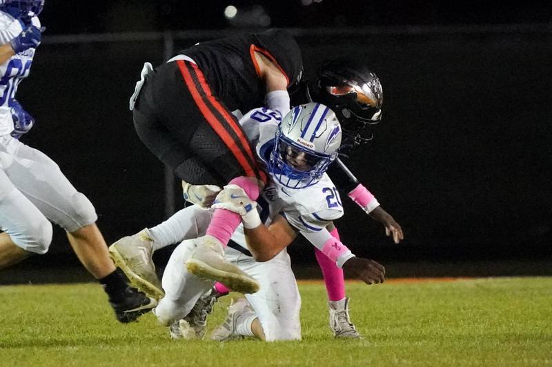 Woodstock's Logan Wisner (20) tackles Sandwich’s Nick Michalek (11) during a football game at Sandwich High School on Friday, Oct. 11, 2024.