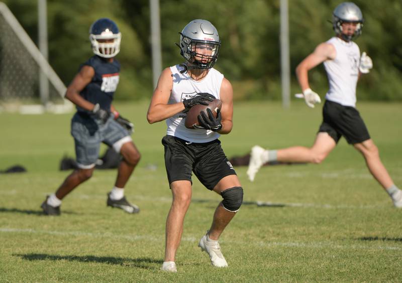 The Kaneland offense completes a pass during a 7 on 7 football against Oswego in Maple Park on Tuesday, July 12, 2022.