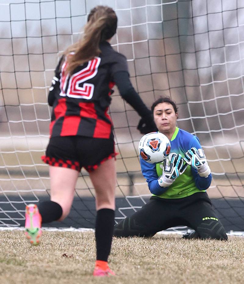 Genoa-Kingston keeper Zoe Nieves makes a save as Indian Creek's Emma Turner charges the net during their game Thursday, March 16, 2023, at Pack Park Sports Complex in Waterman.