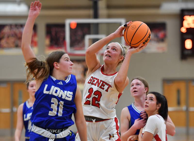Benet’s Bridget Rifenburg (22) shoots as Lyons Township’s Benet’s Evie Riopell (31) defends during a game on November 18, 2025 at Benet Academy in Lisle.
