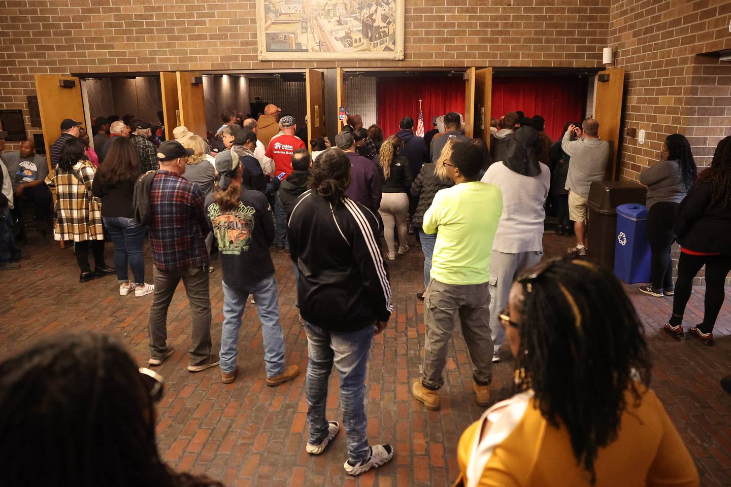 Dozens stands in the foyer of the Billie Limacher Bicentennial Park theater of Joliet Township meeting as residents want answer or the township asylum grant money on Tuesday, Oct. 10, 2023 in Joliet.