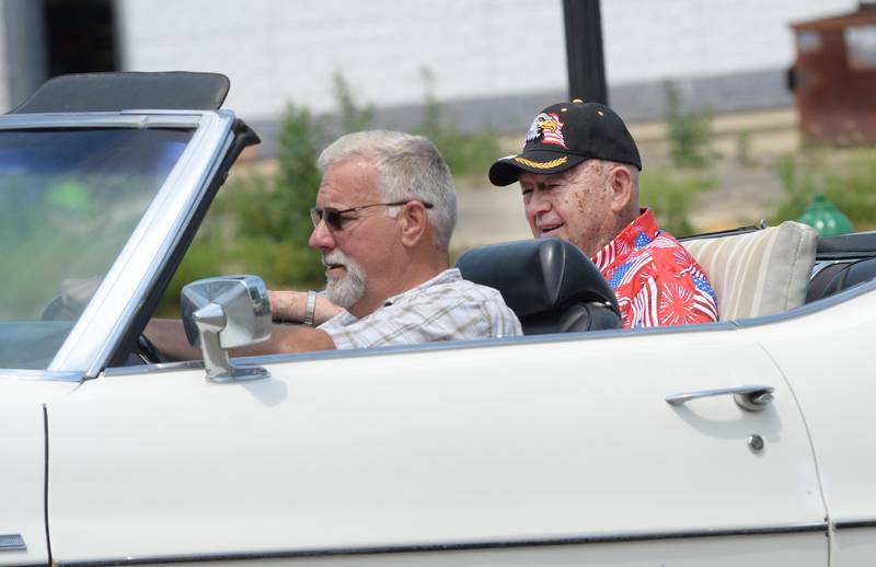 John Thompson, the 2025 Let Freedom Ring Parade Marshal, rides in a convertible driven by former Mt, Morris Chief of Police Jason White during the Let Freedom Ring parade on Friday, July 4, 2025 in Mt. Morris.