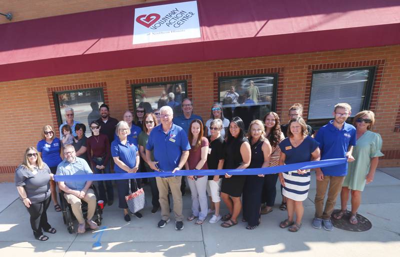 Nate Kloster, executive director at the Voluntary Action Center (center) cuts the ribbon on the facilities new space on Wednesday, Aug. 13, 2025 in the former Peru Pizza House downtown Peru. VAC is a nonprofit organization committed to serving La Salle, Bureau and Putnam counties through essential programs such as Meals on Wheels and congregate dining.