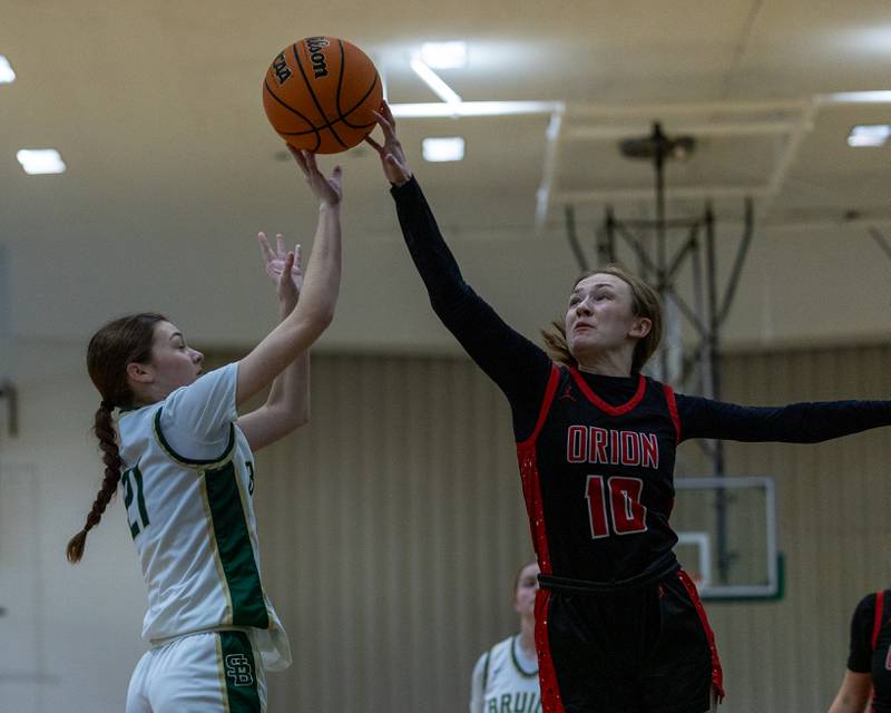 Parker McClain (21) of St. Bede shoots 3-pointer but gets blocked by Thea Seys (10) of Orion on Friday, December 26, 2025 at St. Bede High School in Peru.