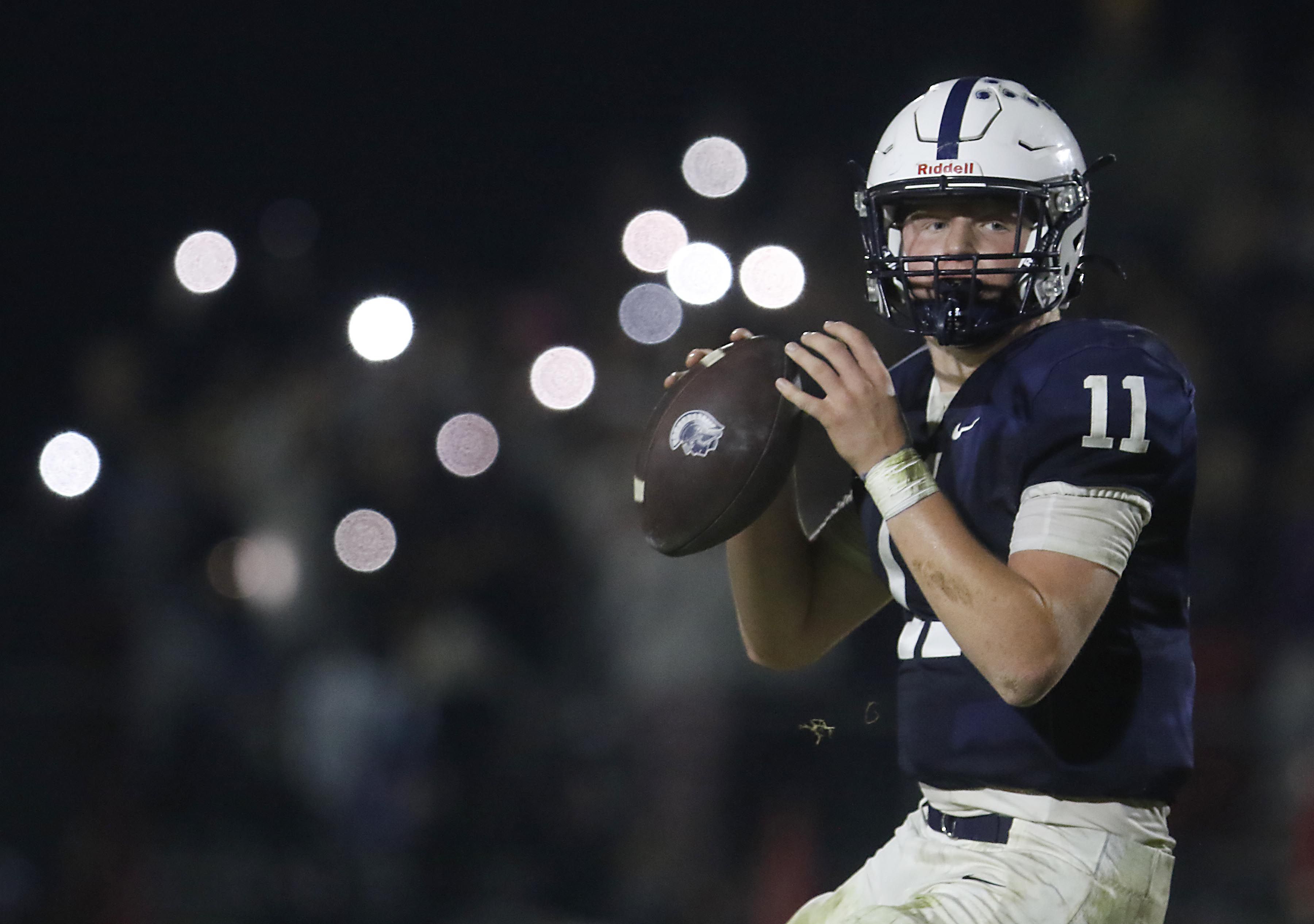 Cary-Grove's Jackson Berndt  looks to pass in the final minute of Cary-Grove’s loss to Belvidere North in an IHSA Class 5A quarterfinal playoff football game on Friday, November 14, 2025, at Cary-Grove High School, in Cary.