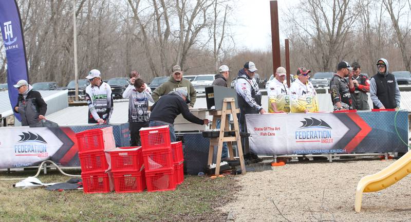 Anglers wait their turn in line to weigh their fish during the annual Masters Walleye Circuit tournament on Friday, March 21, 2025 at the Spring Valley Boat Club.