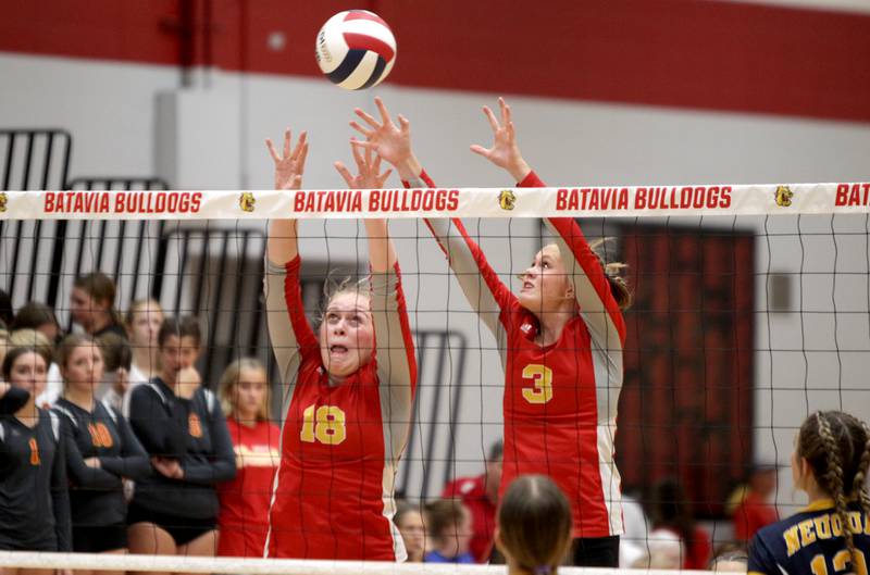 Batavia’s Brookelyn Vandeloo (left) and Sydney Enger (right) go up for a block during a home game against Neuqua Valley on Tuesday, Aug. 29, 2023.