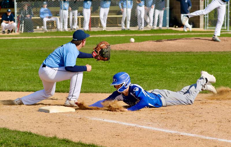 Princeton's Bennett Sierens dives back into first base as Bureau Valley's Bryson Smith takes a pickoff throw Thursday in Manlius. The visiting Tigers won 12-6.