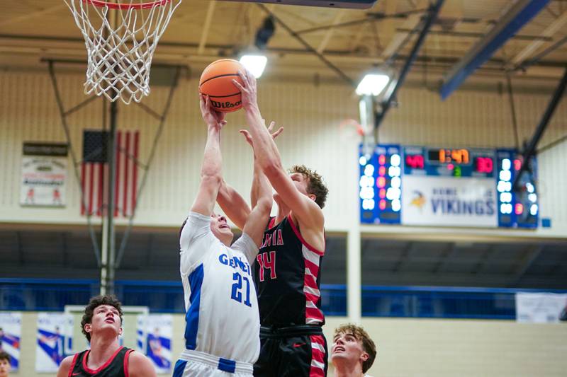 Geneva’s John Tweed (21) and Batavia’s Brett Berggren (14) fight for a rebound during a basketball game at Geneva High School on Friday, Feb. 7, 2025.