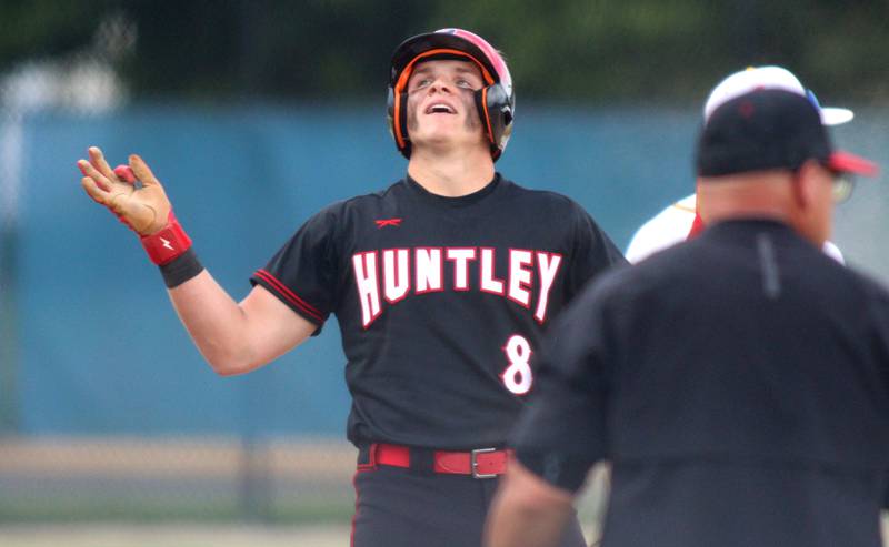 Huntley’s Brayden Bakes celebrates after landing at third base safely with a triple against Jacobs in Class 4A Sectional baseball action at Carpentersville Wednesday.