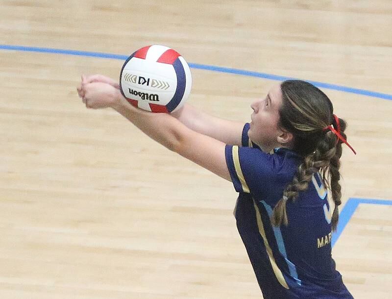 Marquette's Makayla Backos returns a serve from Woodland on Thursday, Oct. 19, 2023 at Bader Gym.