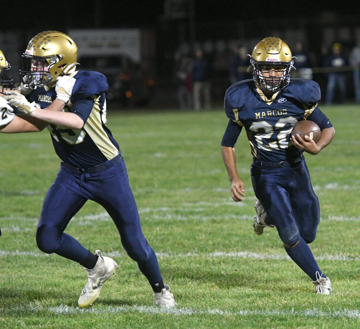 Polo's Delo Fernandez runs for a gain as Landon Brooks (45) blocks during 8-man playoff action against Hiawatha on Friday, Oct. 28.