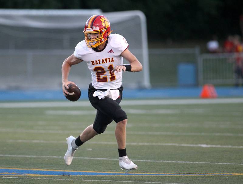 Batavia quarterback Ryan Boe keeps the ball during a game at Wheaton North on Friday, Sept. 9, 2022.