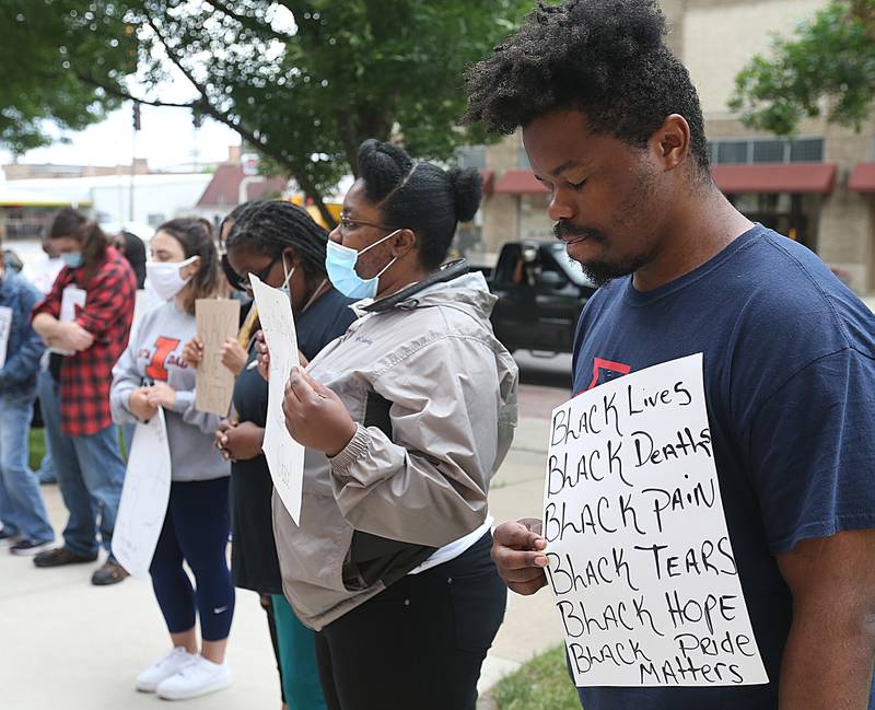 A protester holds a sign describing "black lives, death, pain, tears, hope, and pride matters" while observing eight minutes and forty-five seconds of silence in remembering the death of George Floyd on June 10th in La Salle.