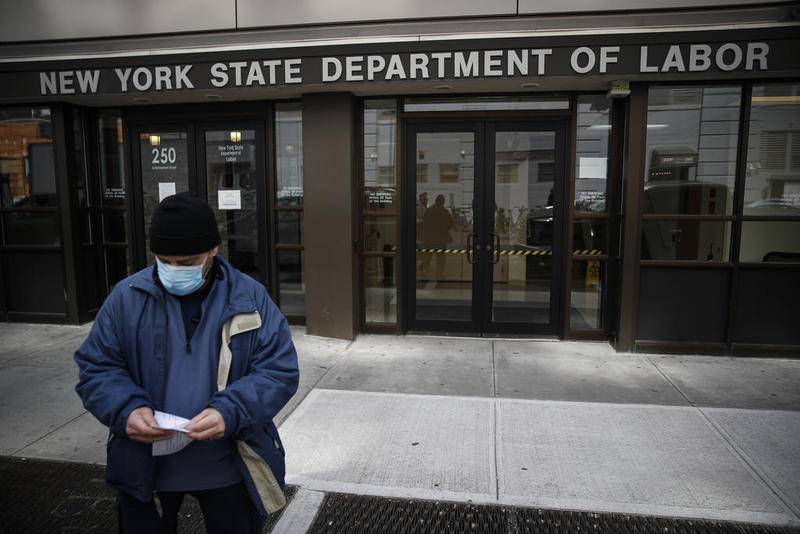 FILE - In this March 18, 2020 file photo, visitors to the Department of Labor are turned away at the door by personnel due to closures over coronavirus concerns. The coronavirus pandemic has already hurt many households financially. Americans have been hit with layoffs, furloughs and reduced hours across the country. Those who have not are still facing massive economic uncertainty. Experts say it's more important than ever to manage your budget, reach out to lenders and seek protections available to those hit by the economic impact of the virus. (AP Photo/John Minchillo, File)
