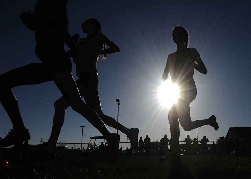 Girls run the  3200 meter run Thursday, April 21, 2022, during the McHenry County Track and Field Meet at Richmond-Burton High School.