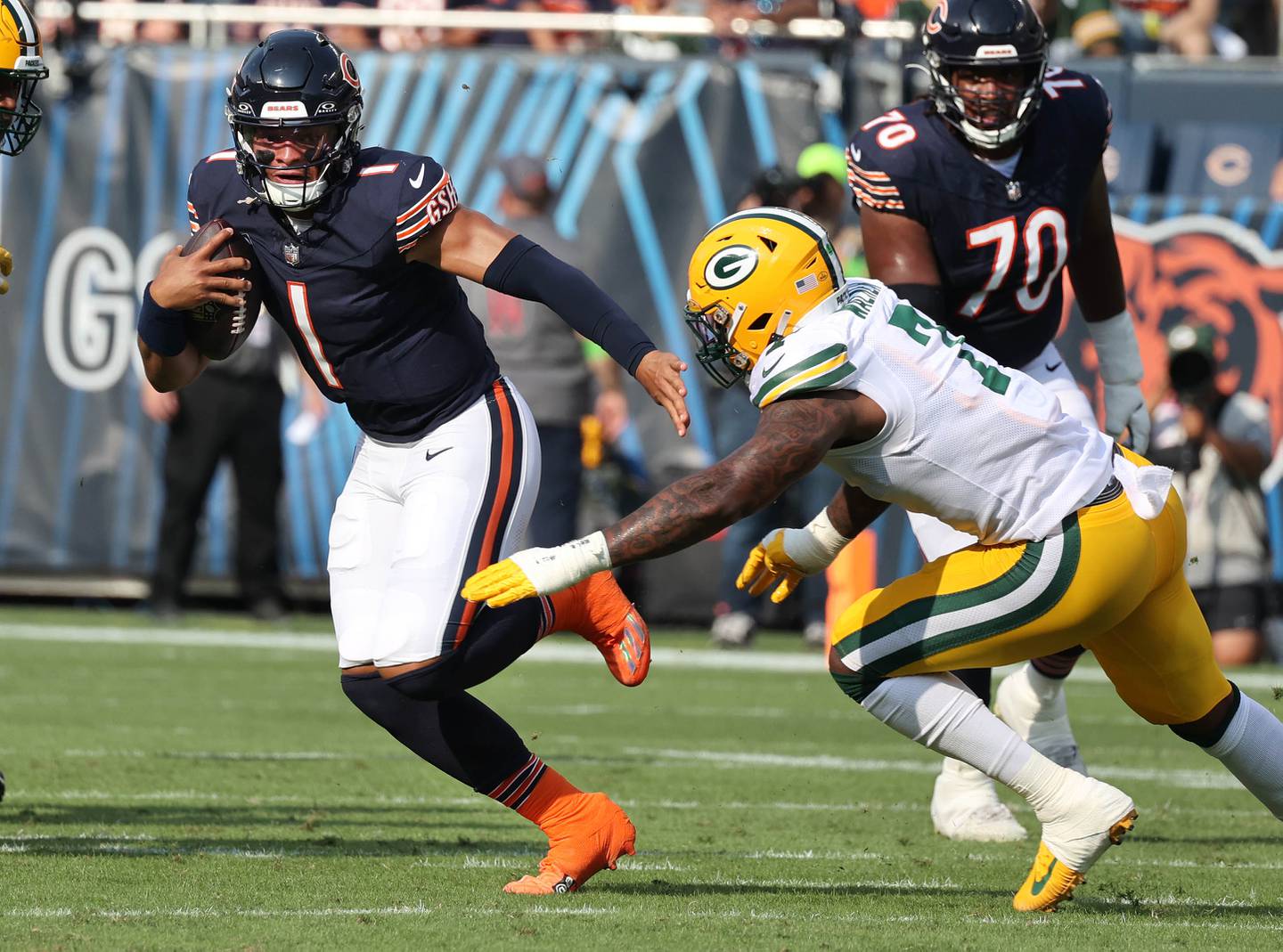 Chicago Bears quarterback Justin Fields escapes the pass rush of Green Bay Packers linebacker Quay Walker during their game Sunday, Sept. 10, 2023, at Soldier Field in Chicago.