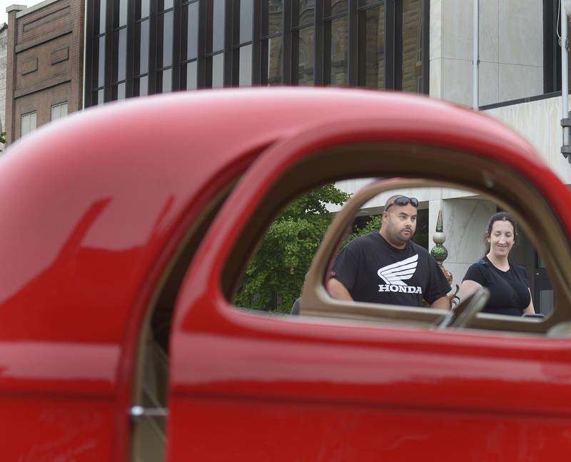 This couple is frames by the window of a Willy’s Coupe Friday night during the 27th annual Cruise Night in Ottawa. The event is put on by the La Salle County Cruisers.