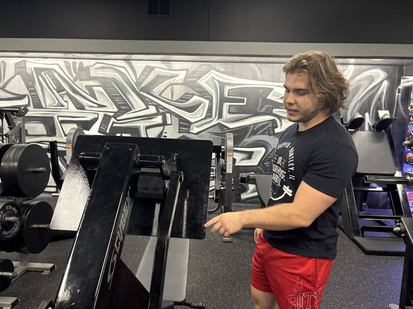 Anthony Yatos shows off a machine at Warhouse Barbell in Huntley Sept. 3, 2025.