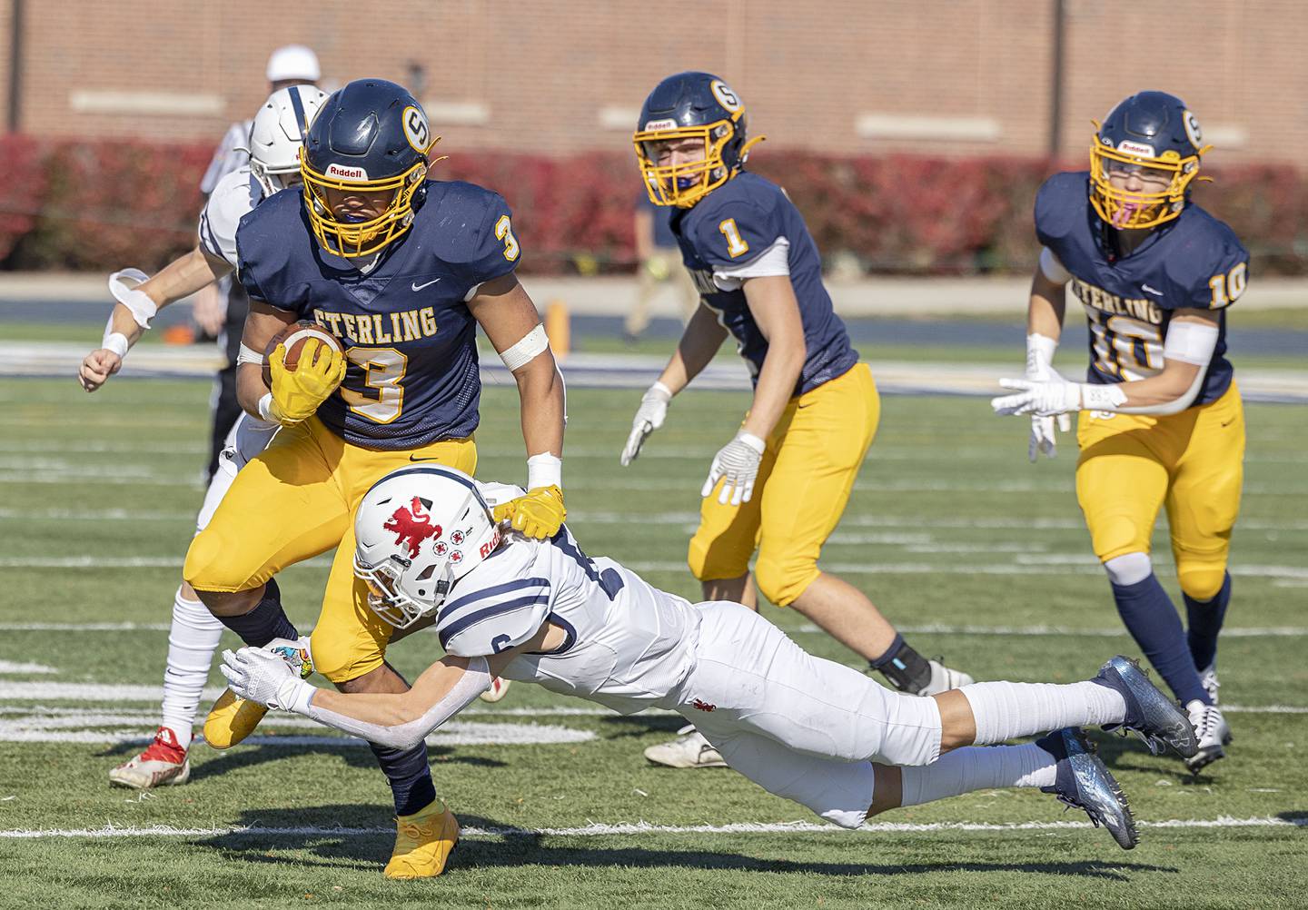 Sterling’s Antonio Tablante is tackled by St. Viator’s Driese Raap in their first round playoff game Saturday, Oct. 29, 2022.
