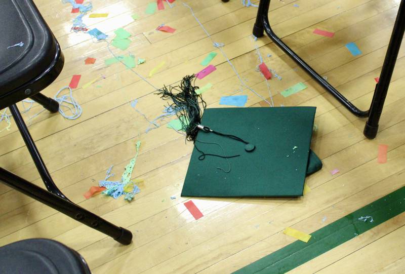 A graduate's cap lays forgotten amid the confetti on the gymnasium floor after  the Class of 2022 at Rock Falls High School has filed out.