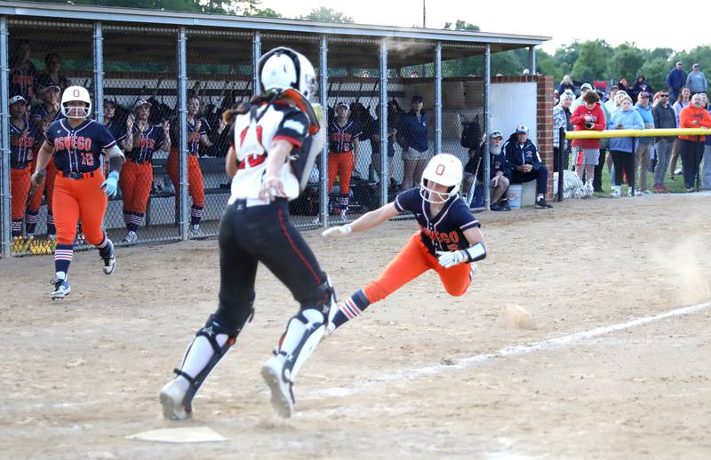 Oswego’s Adalynn Fugitt slides into first base but is called out during a Class 4A Benedictine Supersectional against Marist on Monday, June 9, 2025 in Lisle.