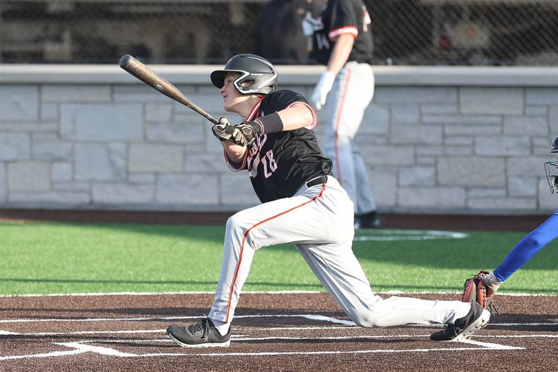 Minooka’s Mason Vogt drives in a run against Joliet Central on Monday, April 6, 2026 in Joliet.