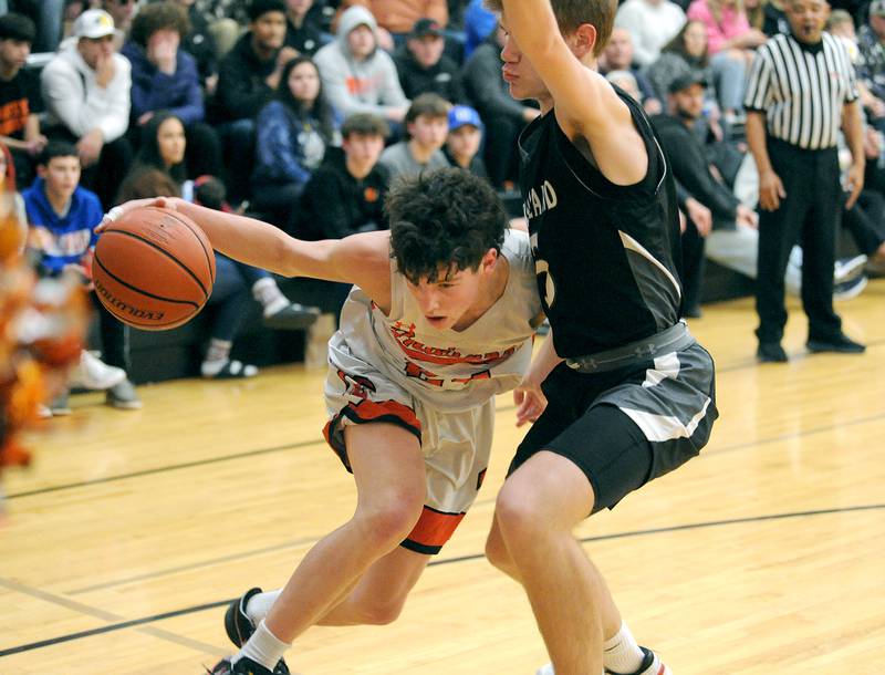 Sandwich's Evan Gottlieb tries to drive past Kaneland defender Brad Franck during a boys' basketball game at Sandwich High School on Friday, Jan. 13, 2023.