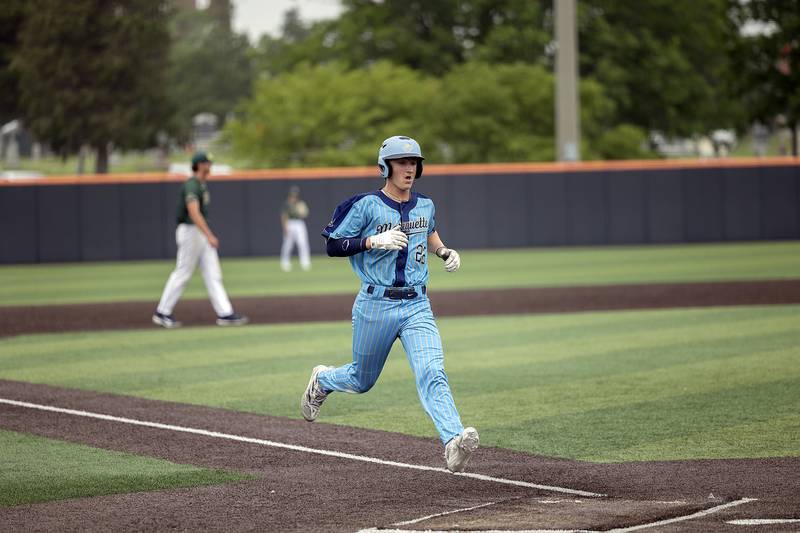 Ottawa Marquette’s Griffin Dobberstein scores against Father McGivney Saturday, June 7, 2025, during the Class 1A state baseball final at Illinois Field in Champaign.