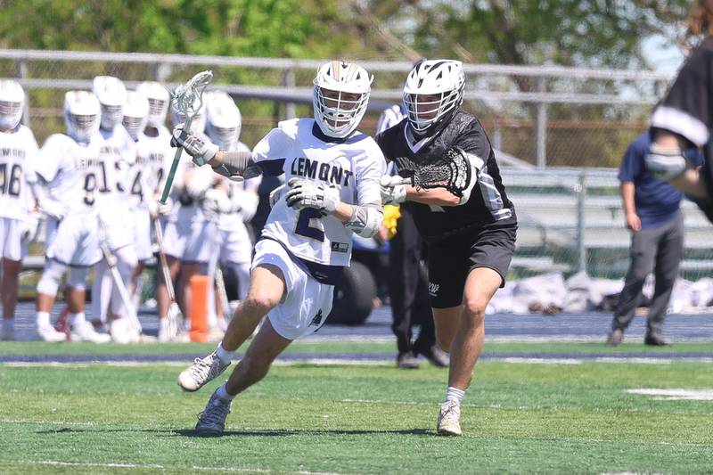 Lemont’s Amadeus Merrion charges the net against Lincoln-Way on Saturday, April 25, 2026 in Lemont.