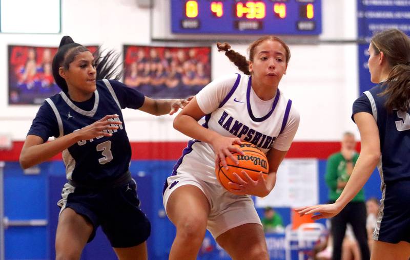 Hampshire’s Mikala Amegasse, center, moves the ball against South Elgin in varsity girls basketball Komaromy Classic tournament  action on Monday, Dec. 29, 2025, at Dundee-Crown High School in Carpentersville.