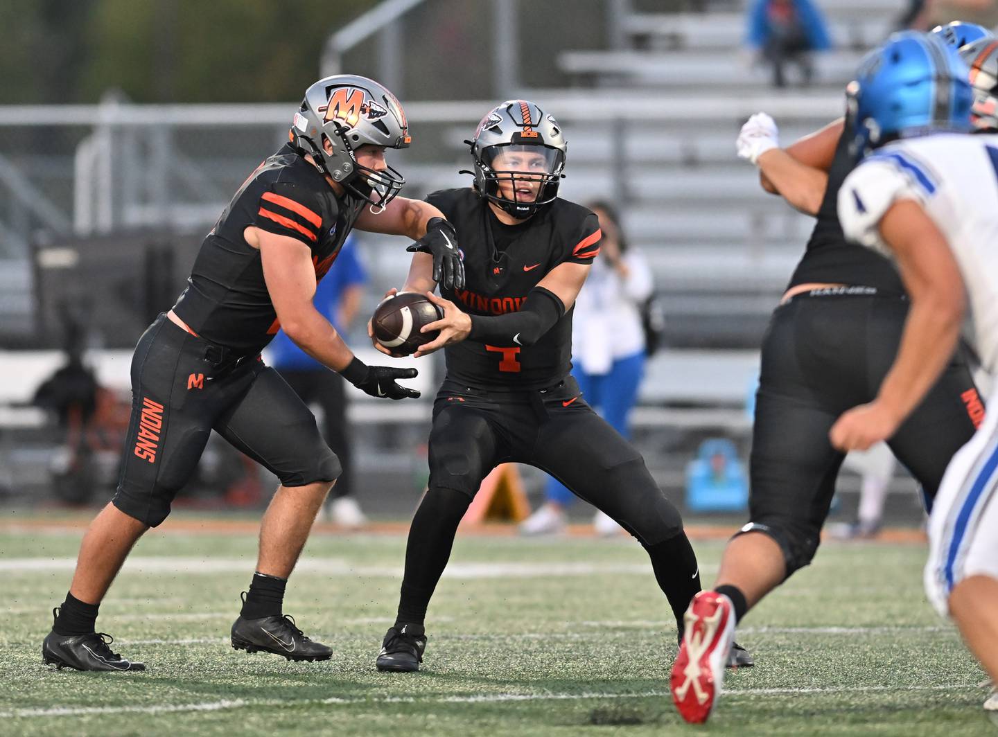 Minooka's Zane Caves (4) hands the off to Minooka's Chase Nurczyk (2) during the non-conference game against St. Charles North on Friday, Aug. 29, 2025, at Minooka.