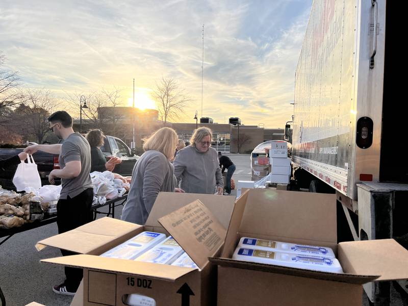 Volunteers assist with a mobile food pantry event on Monday, Nov. 6, 2023, outside of a Joliet veteran affairs clinic.